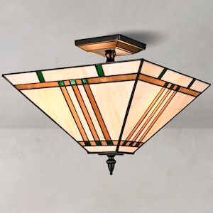 May include: A square ceiling light fixture featuring a stained glass shade with cream, amber, and green geometric panels. The frame is dark bronze metal with a square mounting base and a decorative finial at the bottom center of the shade.