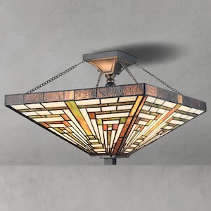 May include: A square, stained-glass ceiling light fixture with a geometric pattern in shades of brown, green, and cream. The fixture is suspended by chains and has a bronze-colored metal frame.