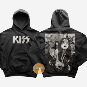 May include: Black hoodie featuring the band KISS logo in white on the front. The back of the hoodie displays a black and white image of a band member with face paint. The hoodie has a hood and a front pocket.