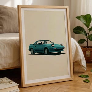 May include: A framed art print featuring a teal sports car with pop-up headlights and a rear spoiler, illustrated in a flat graphic style against a solid light beige background, displayed in a simple light-colored wooden frame.