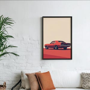 May include: A framed wall art print featuring a side profile of a red vintage muscle car. The car is positioned on a solid red ground against a light beige background. The artwork is enclosed in a thin black frame, showcasing the car's classic design.