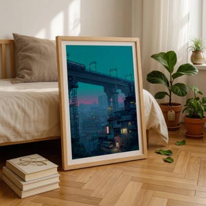 May include: A framed art print featuring a digital illustration of a city at twilight. The scene depicts a train on an elevated track above buildings with glowing windows, set against a teal and pink sky. The frame is light-coloured wood.