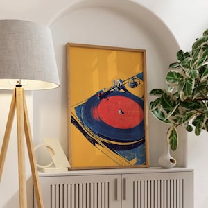 May include: A rectangular framed wall art print featuring a stylized illustration of a record player. The artwork displays a vibrant yellow background with a dark blue turntable and a bright red vinyl record centered on the platter.
