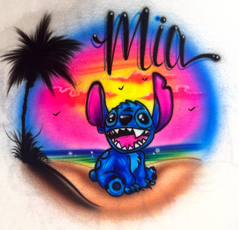 May include: A vibrant illustration featuring a blue cartoon character with large ears and a wide grin, set against a colorful sunset backdrop. The word "Mia" is written above the character in a stylized script. A palm tree and birds are also included.