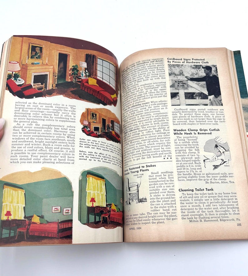 May include: Open book with illustrations of interior design, including rooms with fireplaces, furniture, and color schemes. The pages also feature text on home improvement topics and DIY projects.