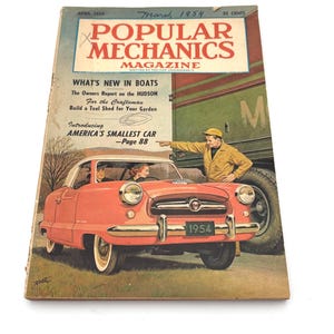 May include: A vintage cover of Popular Mechanics magazine from March 1954. The cover features a coral-colored car with a white roof, a man pointing at the car, and the text "America's Smallest Car." The magazine is slightly worn.