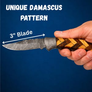 May include: A folding pocket knife with a 3-inch Damascus steel blade featuring a wavy pattern. The handle is constructed from alternating light and dark wood pieces arranged in a chevron pattern, secured with small brass pins. Text reads UNIQUE DAMASCUS PATTERN.