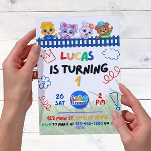 May include: A birthday invitation held by hands. The invitation features the text "LUCAS IS TURNING 1" with cartoon characters and a blue fence design. Additional text includes date, time, and RSVP information.
