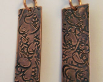 Hand hammered designs into heated Copper with hand-forged copper wires and crystal drop