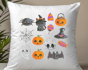 May include: White square pillow featuring cross-stitch Halloween-themed designs. The designs include a spider, cat, pumpkin, candy, witch hat, skull, ghost, and bat. The color palette includes orange, purple, black, and white.