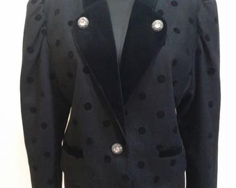 May include: A black polka dot blazer with a velvet collar and cuffs. The blazer has three silver buttons.