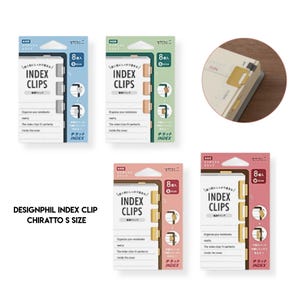 May include: Four packages of Designphil Chiratto S size index clips in blue, green, pink, and red. Each package contains eight metal clips with tabs for notebooks. A circular inset shows the gold-coloured clips attached to the edge of a page.