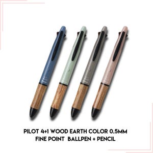May include: Four multi-coloured Pilot 4+1 Wood Earth Color 0.5mm fine point ballpoint pens with a pencil. The pens have a wooden barrel with a natural wood grain finish. The pens are blue, green, grey, and pink.