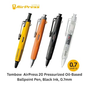 May include: Four Tombow AirPress 20 pressurized oil-based ballpoint pens with 0.7mm tips and black ink. The pens are yellow, orange, black, and clear, each featuring a side clip, a top push-button mechanism, and a visible internal ink cartridge.