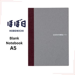 May include: A gray A5 blank notebook with a burgundy spine. The cover has the text "ほぼ日" and "ほぼ日の無地ノート" printed on it.