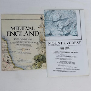 May include: Two National Geographic magazine supplements. The left one is titled Medieval England, featuring a map of England and a castle illustration. The right one is titled Mount Everest, featuring a topographic map of the mountain peak.