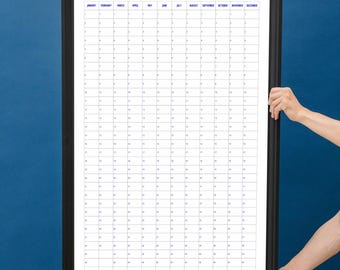 May include: A black framed calendar with white paper and blue text. The calendar shows all 12 months of the year, January through December, with each month having 31 days.