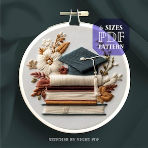 May include: An embroidery hoop featuring a graduation theme. The design includes a stack of books, a graduation cap, and floral elements in white, brown, and teal. The text "6 Sizes PDF Pattern" is visible. The text "Stitcher by Night PDF" is also visible.