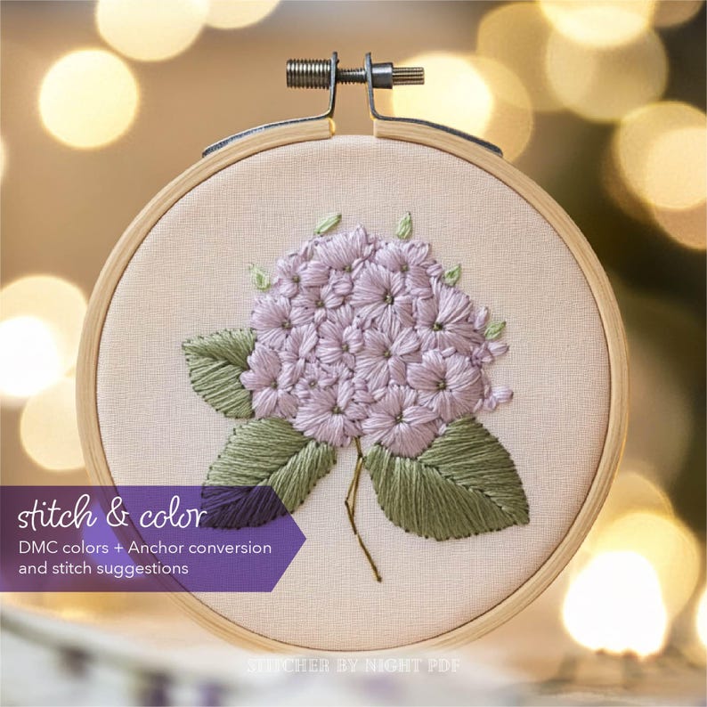 May include: Embroidered hydrangea flower in a hoop with green leaves. The embroidery pattern includes DMC color suggestions and Anchor conversion.
