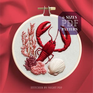 May include: Embroidered lobster design in a wooden hoop. The red lobster is surrounded by coral, a seashell, and the text "6 SIZES PDF PATTERN". The text "Stitcher by Night PDF" is also visible.