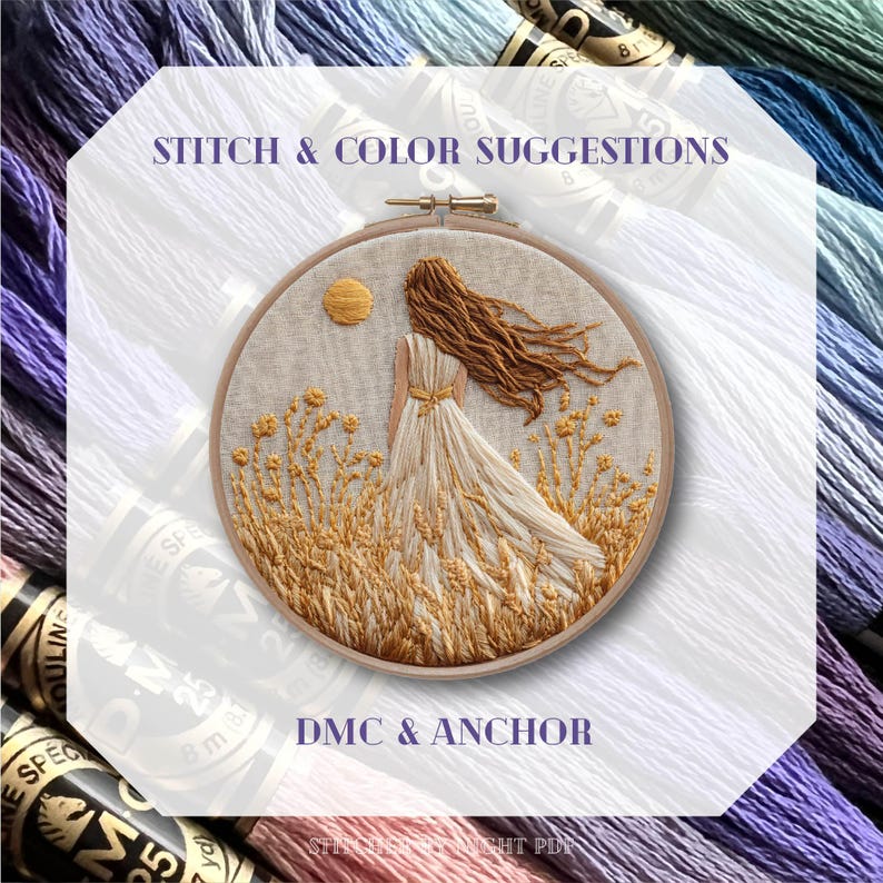 May include: An embroidered artwork in a wooden hoop depicts a woman in a flowing dress, standing in a field of wheat under a sun. The text "STITCH & COLOR SUGGESTIONS" and "DMC & ANCHOR" are visible. Embroidery floss in various colors surrounds the artwork.