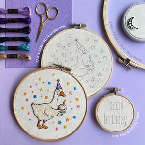 May include: An embroidery kit with a birthday theme. The kit includes embroidery hoops, thread, scissors, and a design featuring a goose holding a cupcake. The text "happy birthday" is also included. The hoops come in sizes from 3" to 8".