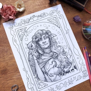 Beautiful Art Nouveau coloring page for Halloween featuring an old witch crowned with flowers in her long gray hair with a pet owl perched on her shoulder. She is blind in one eye but appears both kind and wise. Leaves and candles fill the border.