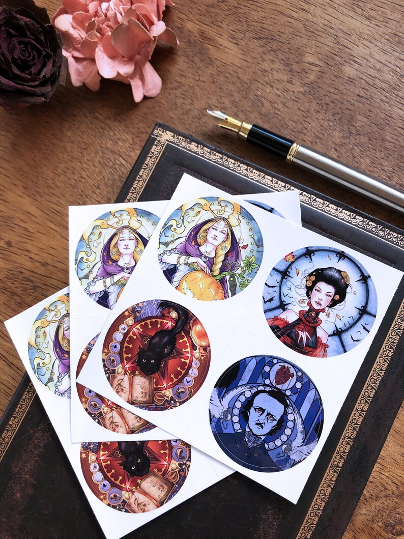 May include: Six round stickers featuring illustrations of a woman with a crown, a woman with a pumpkin, a woman with a clock, a black cat with a book, a man with a heart, and a black cat with a book. The stickers are on a white background.