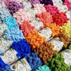 May include: A variety of colorful yarn skeins with the brand name "alize" printed on the labels. The yarn is a fluffy, textured type, perfect for crocheting or knitting.