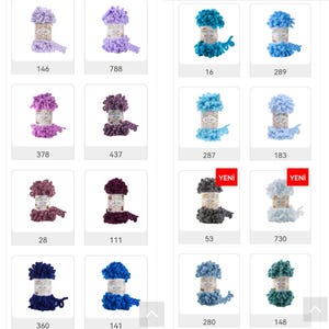 May include: Assortment of colorful yarn balls in various shades of purple, blue, and green. Each ball is labeled with a number. The yarn is fluffy and textured, with a pom-pom effect.
