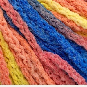 May include: Close-up of colorful yarn in shades of pink, orange, yellow, blue, and purple. The yarn is thick and textured, with a braided appearance. Ideal for knitting, crocheting, or other fiber crafts.