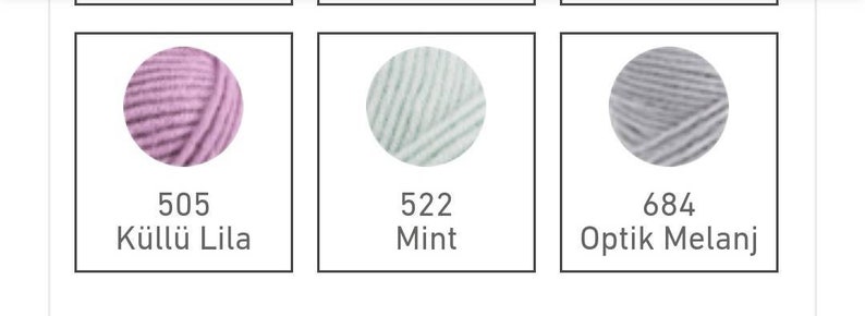 May include: Three balls of yarn in different colours: a light pink ball labelled "505 K&uuml;l&uuml; L&uuml; Lila", a light blue ball labelled "522 Mint", and a grey ball labelled "684 Optik Melanj".