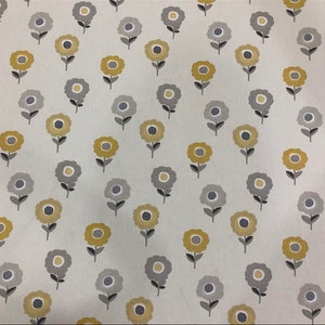 May include: A white fabric with a repeating pattern of yellow and gray stylized flowers. The flowers have a simple design with a circle in the center and four petals.