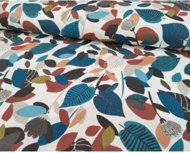 May include: White fabric with a repeating pattern of teal, brown, orange, and beige leaves. The leaves are stylized and abstract.