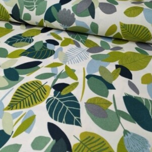 May include: White fabric with a green, blue, and gray leaf pattern. The leaves are stylized and abstract.