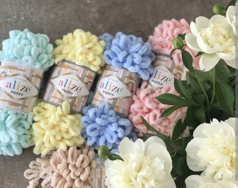 May include: Five skeins of Alize Puffy yarn in different colors: light blue, yellow, blue, pink, and beige. The yarn is soft and fluffy, perfect for crocheting or knitting.