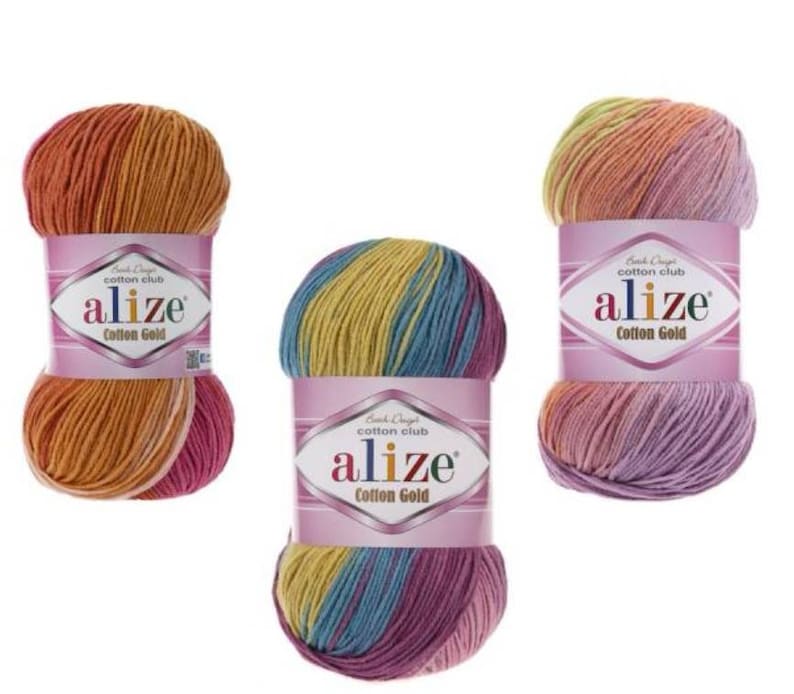 May include: Three skeins of Alize Cotton Gold yarn in various color combinations. The yarn is wrapped with a pink label that has the brand name and product information. The colors include orange, yellow, pink, blue, and purple.