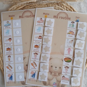 May include: Two beige educational charts with the text "Ma routine" and illustrations of daily activities. One chart has a bear illustration. The charts include the text "Matin" and "Soir" with star-shaped markers.