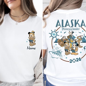 A woman wearing a white t-shirt with a Disney-themed design on the back.