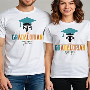 a man and a woman wearing white graduation shirts