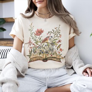 a woman sitting on a couch with a book in her hands