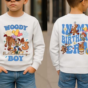 A boy wearing a white sweatshirt with a cartoon character from Toy Story printed on it, celebrating his birthday.