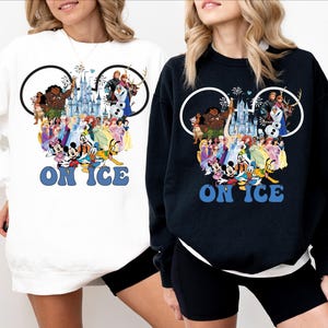 May include: Two sweatshirts with a Mickey Mouse ear design featuring a collage of Disney characters, including Mickey Mouse, Minnie Mouse, Elsa, Anna, and Moana. The text "ON ICE" is printed below the collage. One sweatshirt is white and the other is black.