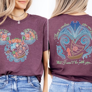 a woman wearing a mickey mouse t - shirt