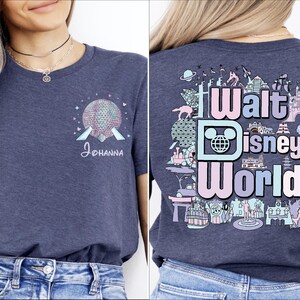 A woman wearing a gray t-shirt with a graphic design featuring Disney World and the text "Walt Disney World" printed on it.