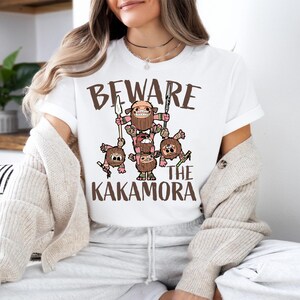 a woman sitting on a couch wearing a t - shirt that says beware of