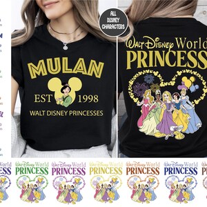 a woman wearing a black shirt with disney princesses on it