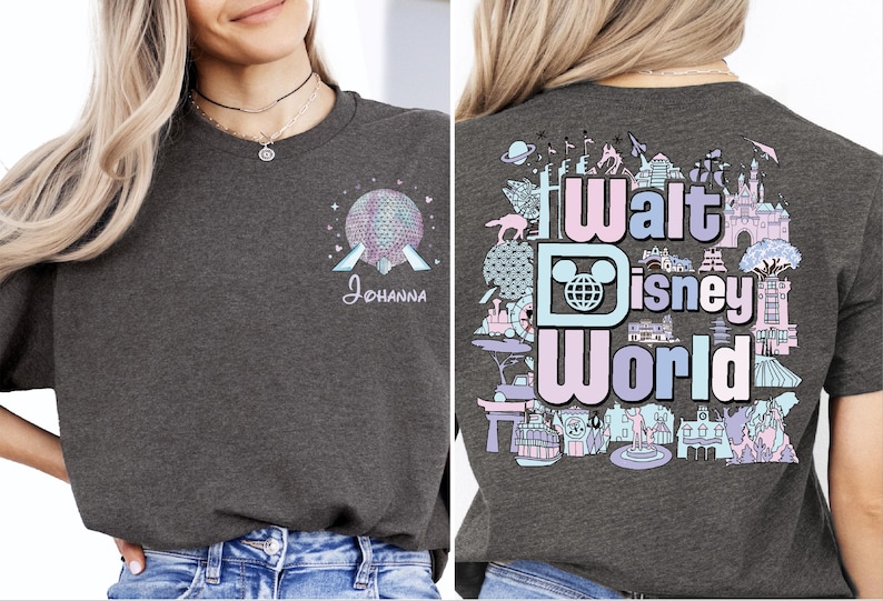 A woman wearing a gray t-shirt with a graphic design featuring Disney World elements, including a roller coaster, castle, and other iconic landmarks.