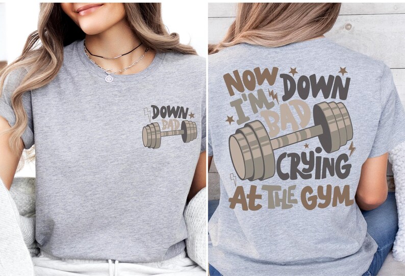 a woman wearing a gray shirt with a barbell on it