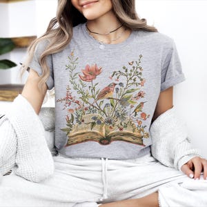 a woman sitting on a couch with a book in her lap